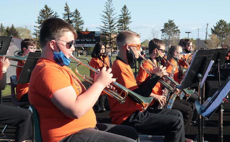 Students outside playing instruments in a band